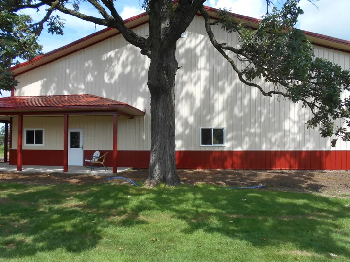 Red exterior wainscot on a cream building with porch