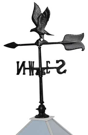 Cast aluminum eagle weather vane with directional letters, on a cupola